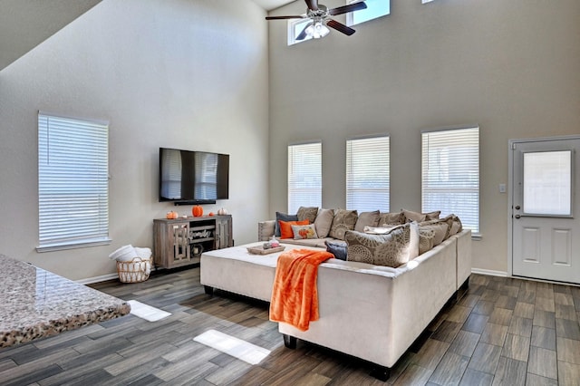 living room featuring a high ceiling and ceiling fan