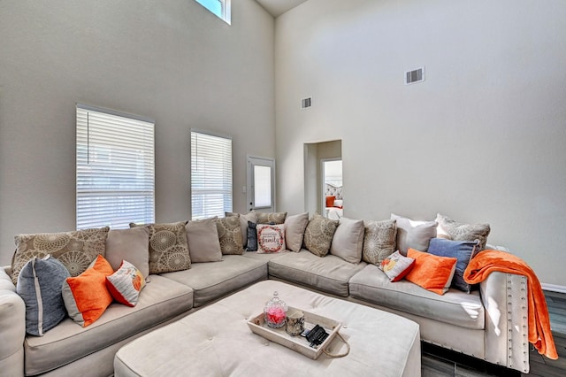 living room featuring a towering ceiling