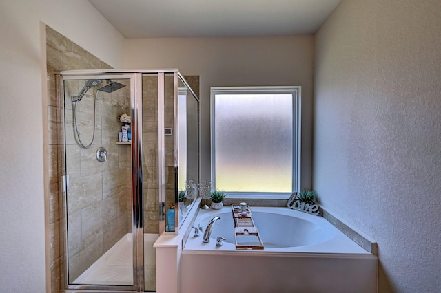 bathroom featuring shower with separate bathtub