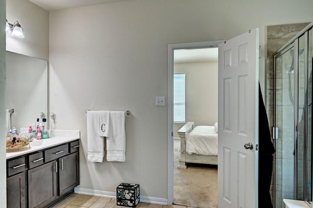 bathroom with vanity and a shower with shower door