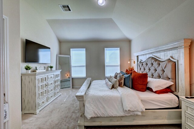 bedroom with lofted ceiling and light carpet