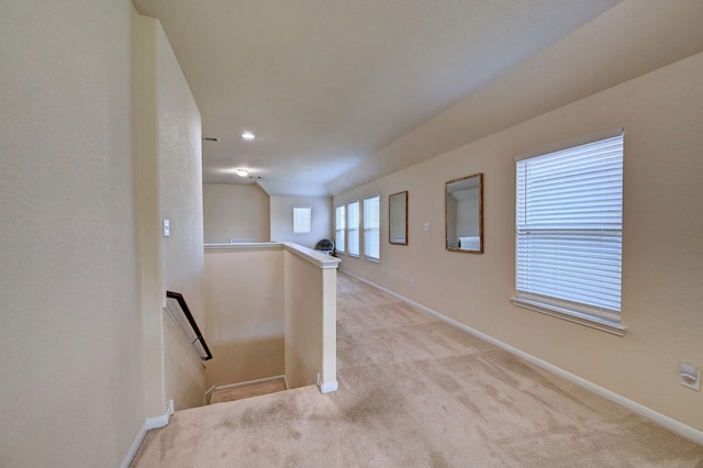 hall with light colored carpet