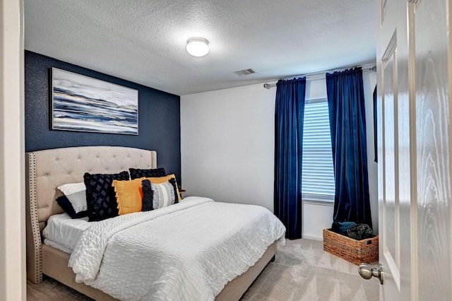 carpeted bedroom featuring a textured ceiling