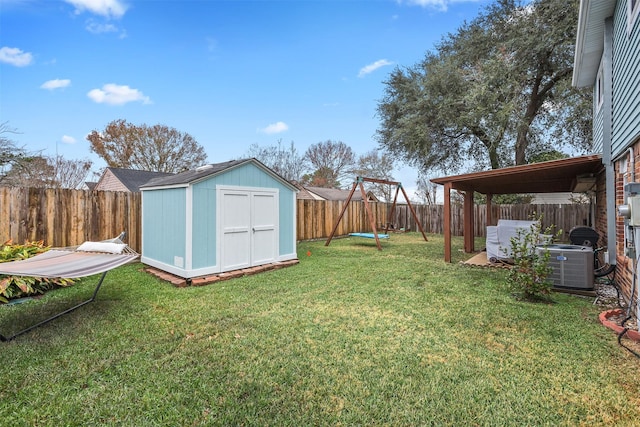 view of yard with central AC and a storage unit