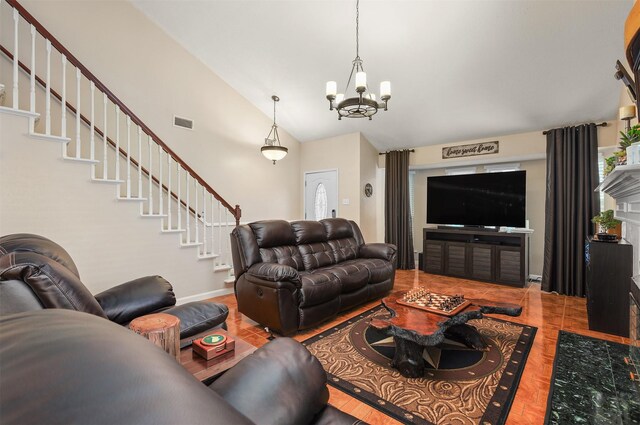 tiled living room featuring an inviting chandelier and vaulted ceiling