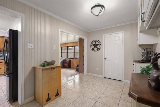 entrance foyer featuring light tile patterned flooring and ornamental molding