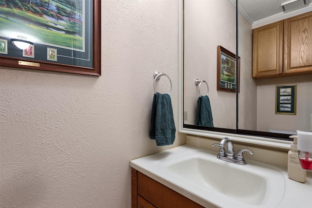 bathroom featuring crown molding and vanity