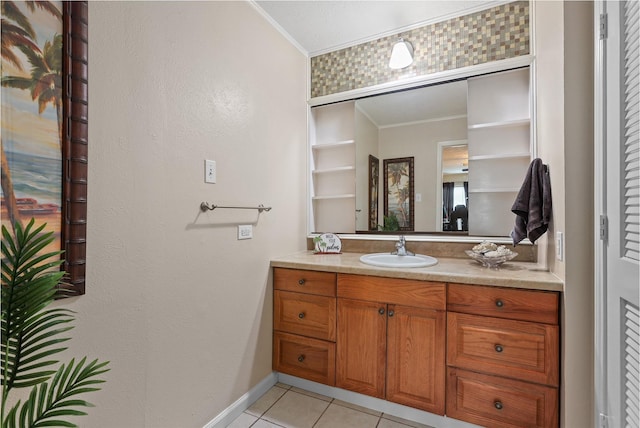 bathroom featuring tile patterned flooring, vanity, and ornamental molding