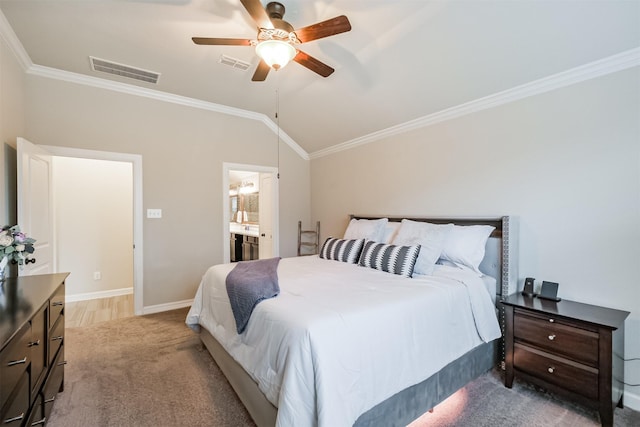 carpeted bedroom featuring vaulted ceiling, ceiling fan, ensuite bathroom, and crown molding