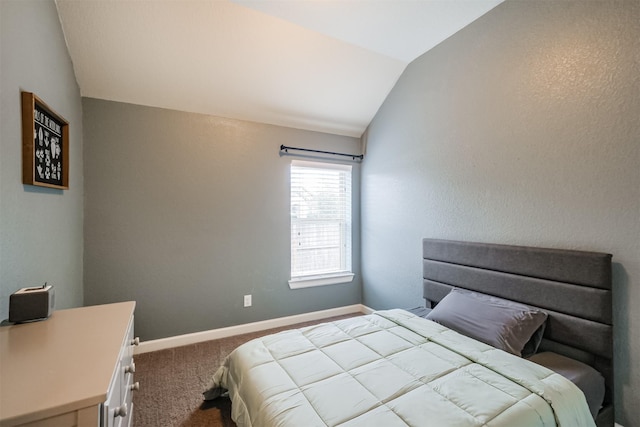 carpeted bedroom with vaulted ceiling