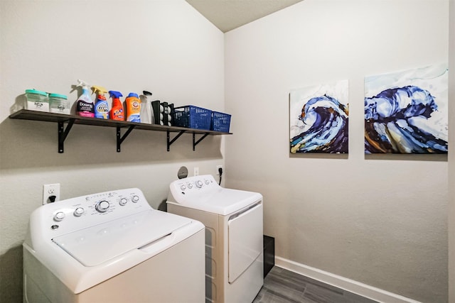 laundry area with washing machine and dryer and dark wood-type flooring