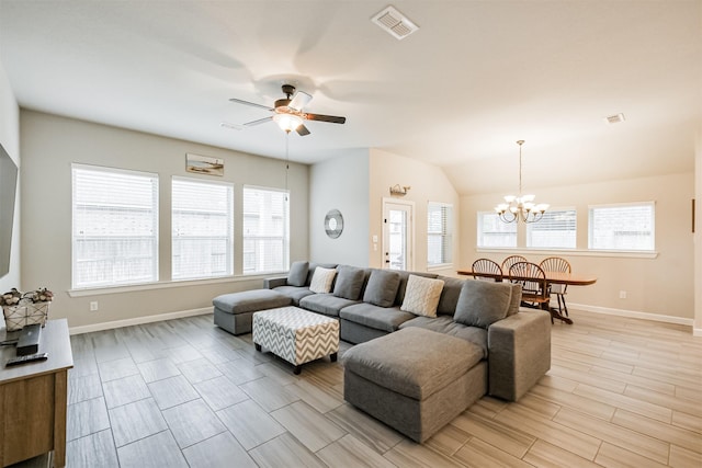 living room featuring ceiling fan with notable chandelier