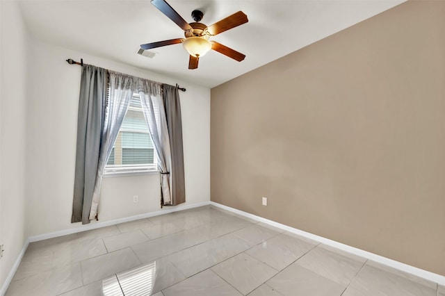 empty room featuring ceiling fan and light tile patterned floors