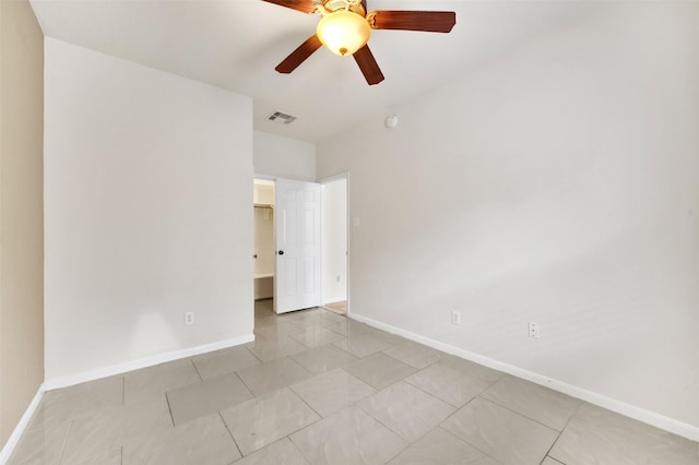 unfurnished room with ceiling fan and light tile patterned floors