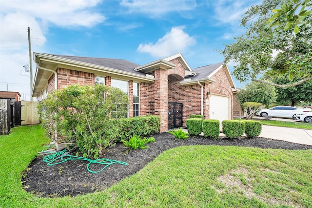 single story home featuring a garage and a front lawn