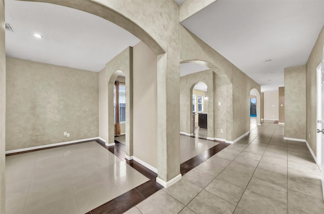 corridor with light tile patterned flooring