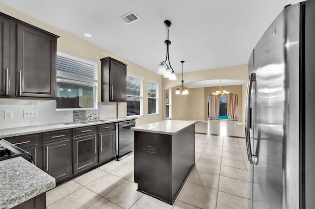 kitchen with a center island, decorative light fixtures, black dishwasher, an inviting chandelier, and stainless steel fridge