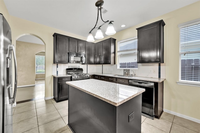 kitchen featuring black appliances, a center island, sink, hanging light fixtures, and light tile patterned floors