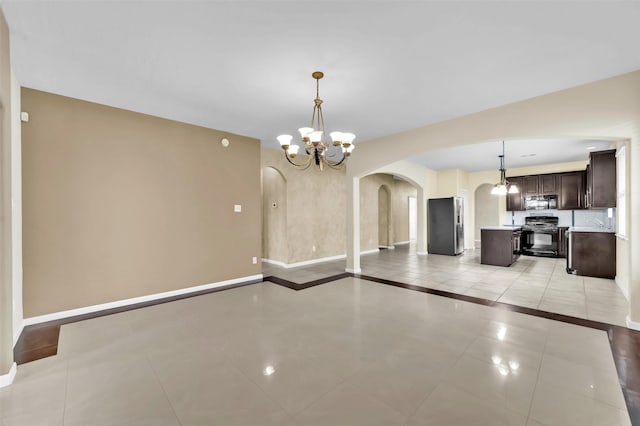 unfurnished dining area with light tile patterned floors and a notable chandelier