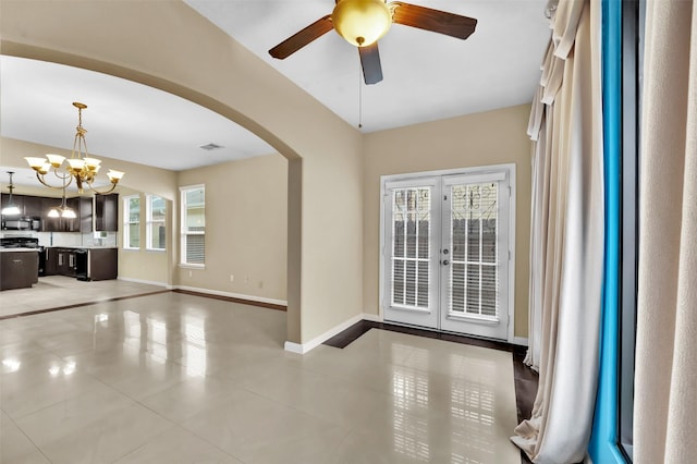 interior space featuring ceiling fan with notable chandelier and french doors