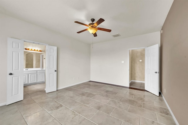 unfurnished bedroom featuring ensuite bathroom and ceiling fan