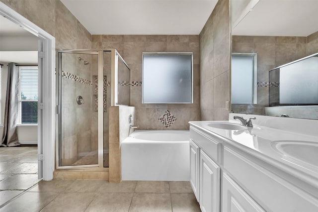 bathroom featuring tile walls, vanity, and shower with separate bathtub