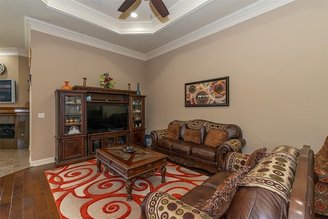 living room featuring ceiling fan, hardwood / wood-style floors, crown molding, and a tray ceiling