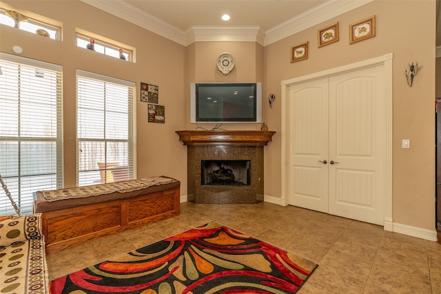 tiled living room with crown molding and a fireplace