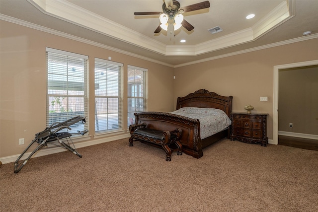 bedroom with a raised ceiling, ceiling fan, carpet, and ornamental molding