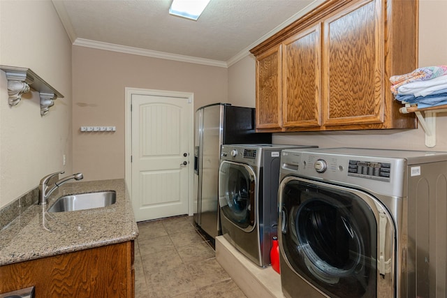 laundry room with sink, crown molding, cabinets, and independent washer and dryer