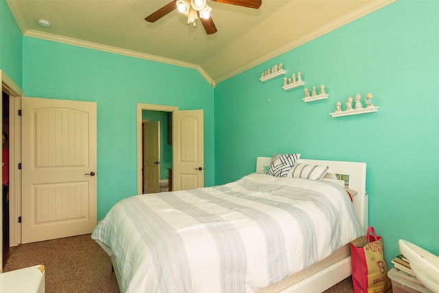 bedroom with ornamental molding, ceiling fan, vaulted ceiling, and carpet floors