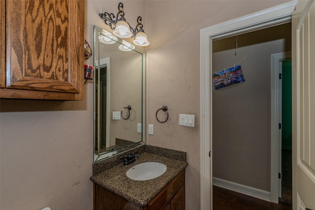 bathroom with hardwood / wood-style floors and vanity