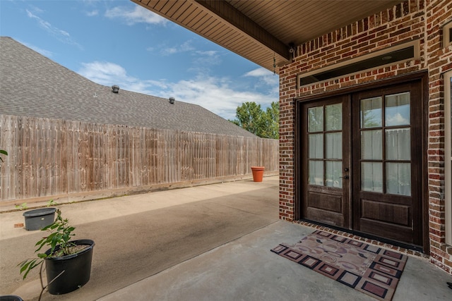 view of exterior entry featuring a patio and french doors