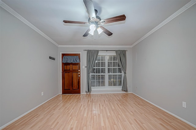 spare room with ceiling fan, light wood-type flooring, and ornamental molding