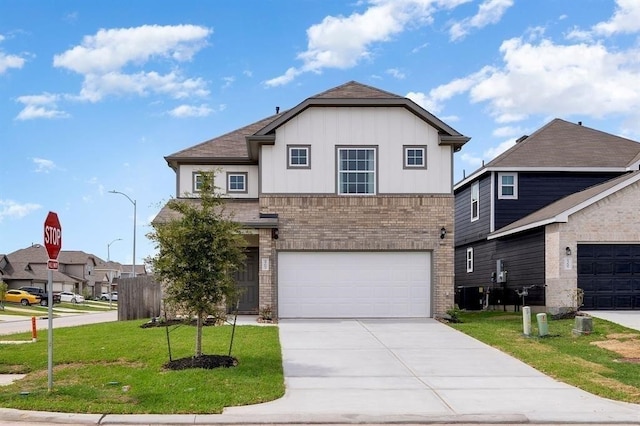 view of front of home with a front yard and a garage