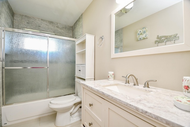 full bathroom featuring toilet, vanity, and combined bath / shower with glass door