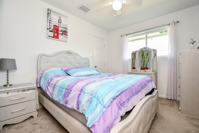 bedroom featuring light colored carpet and ceiling fan