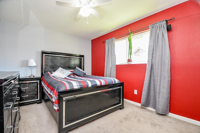 bedroom with ceiling fan and light carpet