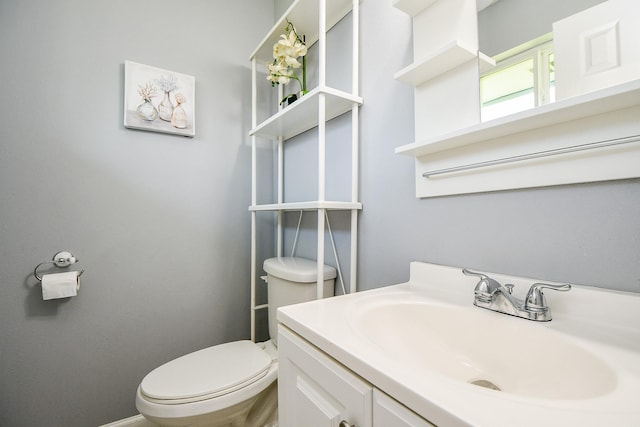 bathroom with toilet and vanity