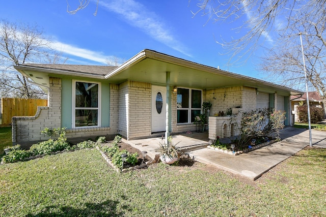 single story home with a garage and a front lawn