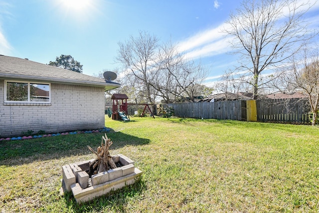 view of yard featuring a fire pit and a playground