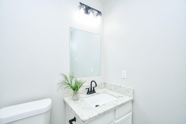 bathroom with toilet and vanity