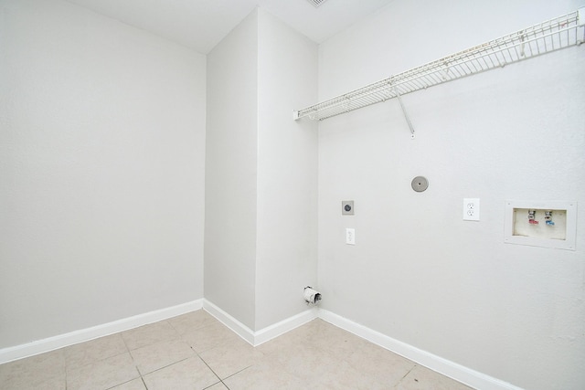 washroom featuring light tile patterned flooring, washer hookup, and hookup for an electric dryer