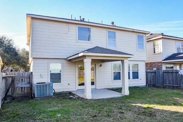 back of house with a yard, a patio area, and cooling unit