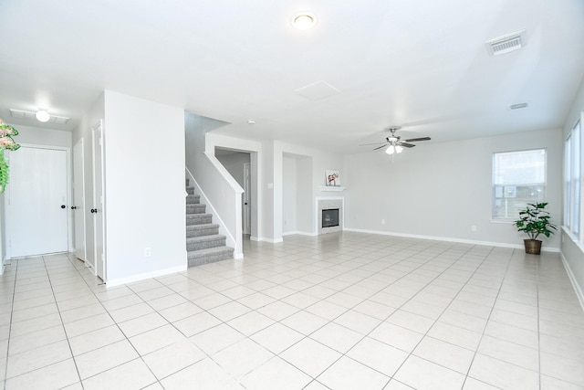 unfurnished living room featuring light tile patterned flooring and ceiling fan