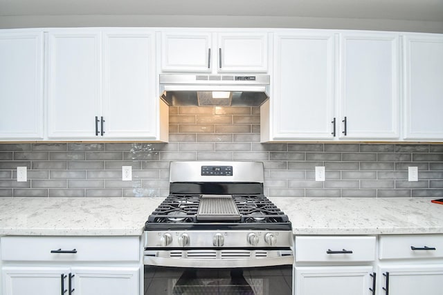 kitchen featuring light stone countertops, white cabinetry, decorative backsplash, and stainless steel gas range oven