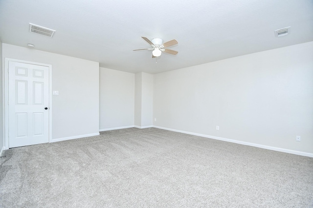 unfurnished room with ceiling fan and carpet