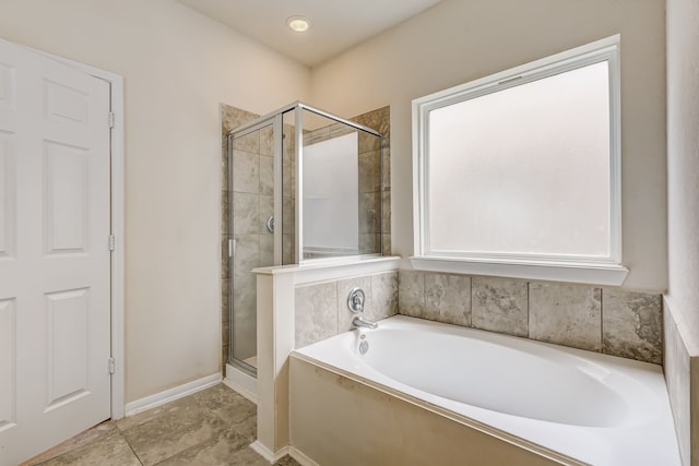 bathroom featuring a healthy amount of sunlight and shower with separate bathtub