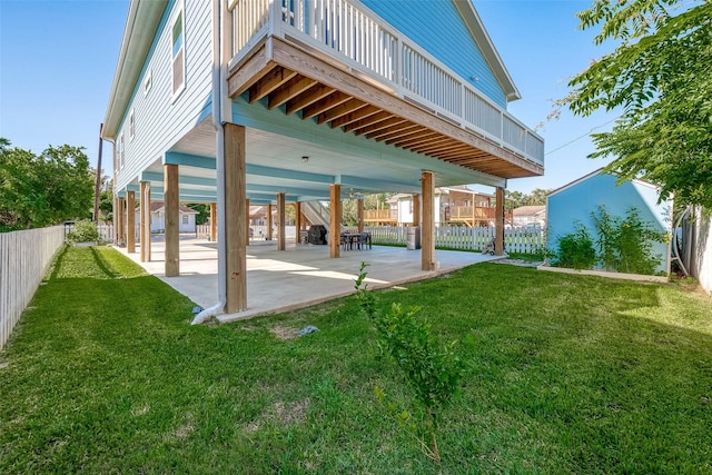 back of property with a lawn and a patio area