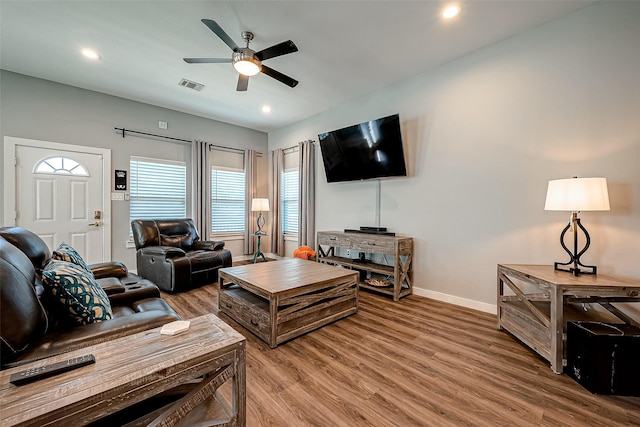 living room with ceiling fan and hardwood / wood-style flooring